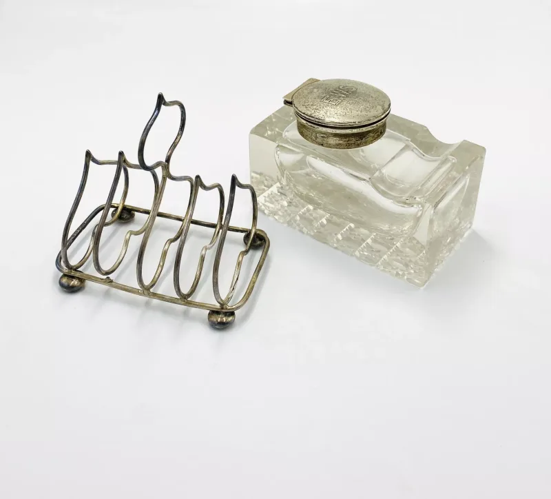 A silver toast rack; together with a cut glass inkwell with silver top
