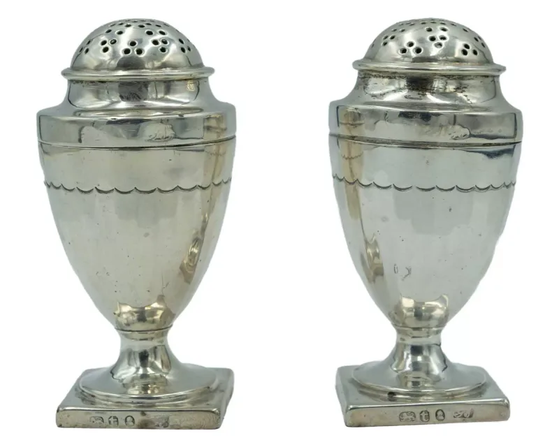 A pair of George III silver salt and pepper casters