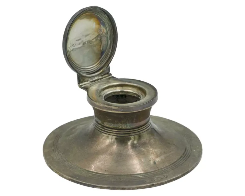 A silver capstan inkwell by William Neale
