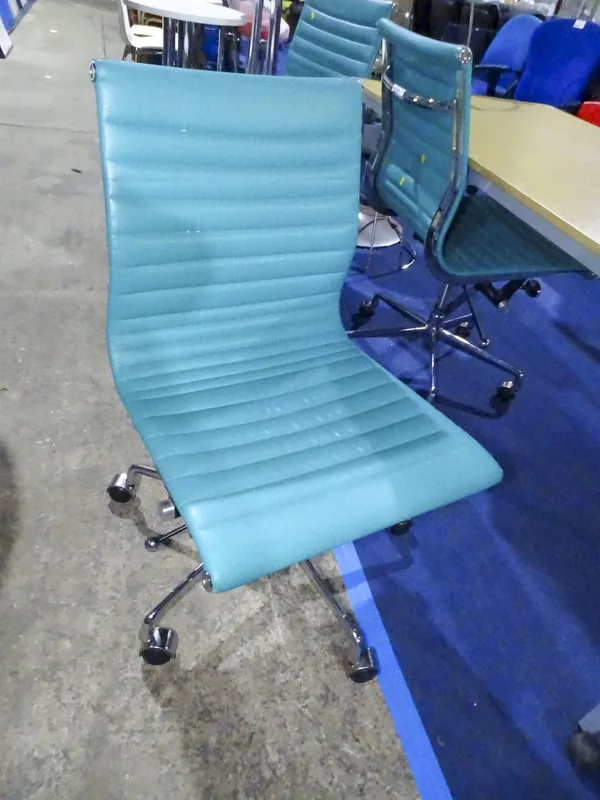 A teal upholstered office swivel chair with chrome frame
