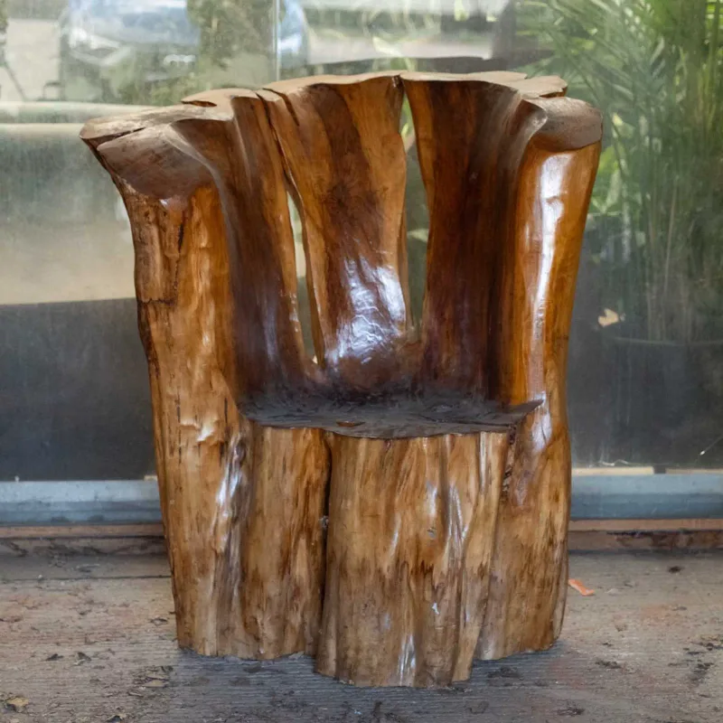A large carved garden seat The seat carved from a single log