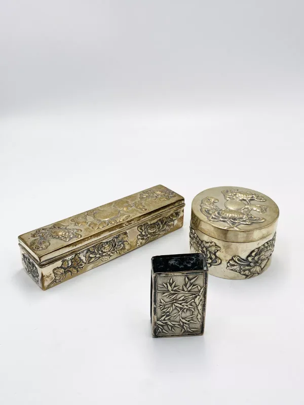 A Chinese white metal matchbox holder together with two other items, total weight: 300g