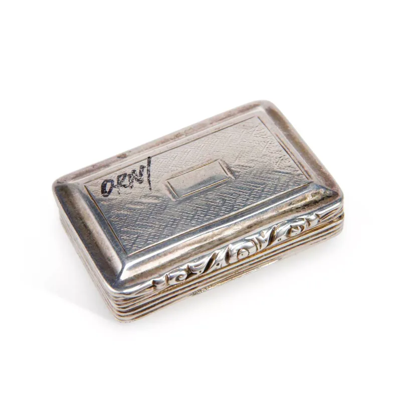 A George IV Silver Vinaigrette maker's mark I.T., Birmingham 1825, of rectangular form with a hinged cover, vacant cartouche, reeded sides