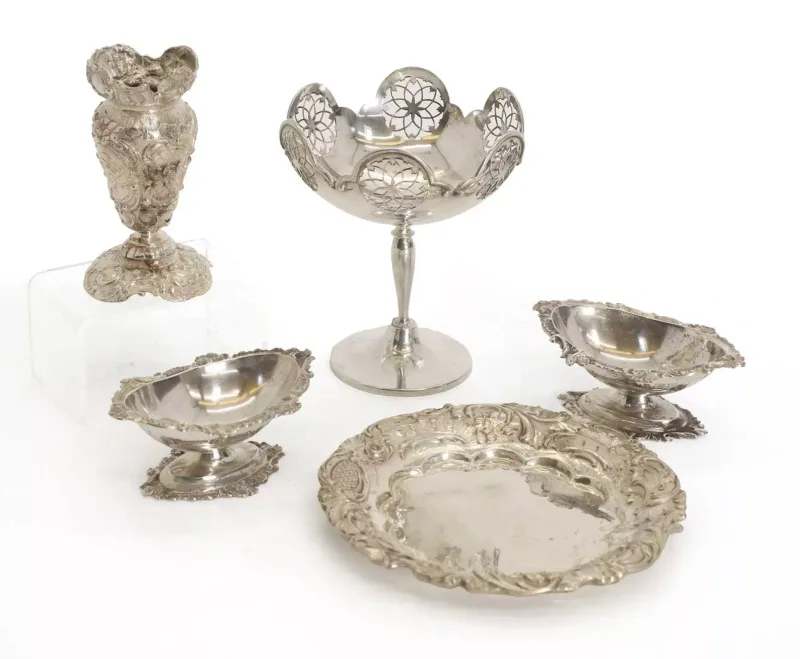 A collection of silver items, various dates, a pair of boat shaped salts, a pierced bowl on a slender column, a import marked vase, and a dish salts