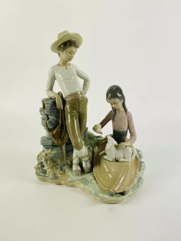 A Lladro porcelain figurine 'Milk For The Lamb', model No.4926, fully marked to the underside. 22cms wide x 17cms deep x 27.5cms high