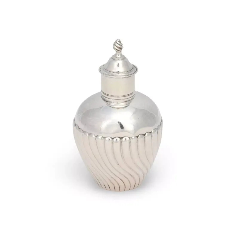 A George III Silver Tea Caddy maker's mark indistinct, London 1788, of ovoid form, the lower body with wrythen lobes beneath a plain shoulder