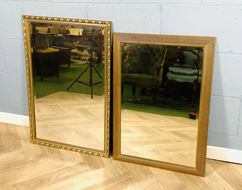 Two decorative rectangular gilt framed mirrors, each with a bevelled plate glass (61cms wide x 86cms high) and (62.5cms wide x 93cms high)