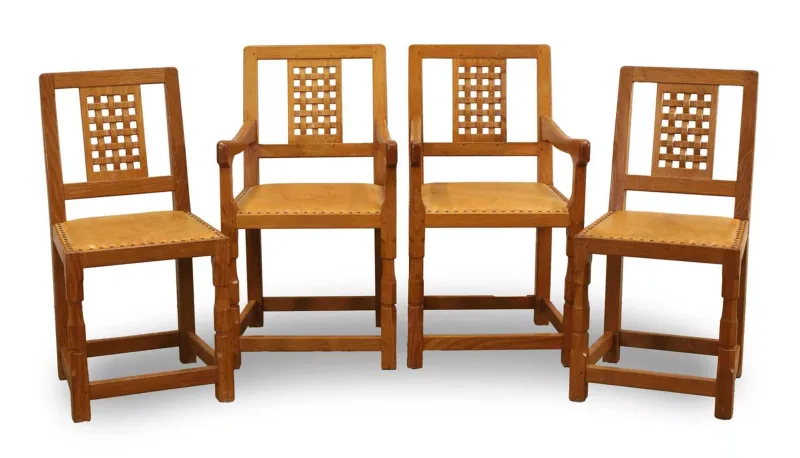 Four Yorkshire School oak chairs, of recent manufacture, in the Mouseman style, two elbow chairs and two single chairs
