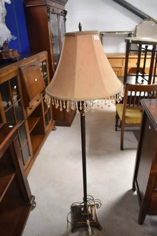 A traditional parcel-gilt and dark patinated metal standard floor lamp