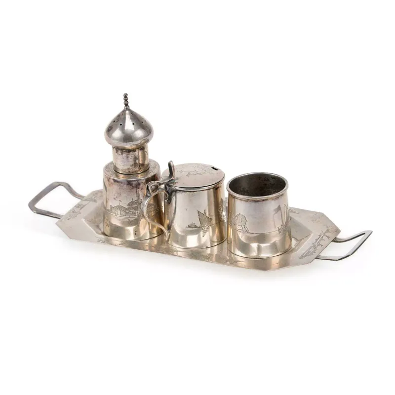 An Iraqi Silver Three-Piece Condiment Set On Tray apparently unmarked, early 20th Century, each engraved with scenes including landscapes, sailing vessels