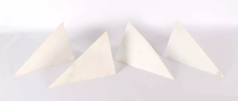 Set of Four Italian Tuscan Carved White Stone Wall Sconces Contemporary manufacture, angular design, each with twin wall fixtures.