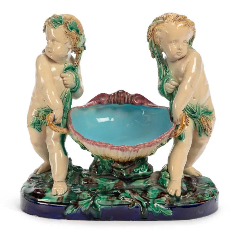 A Minton Majolica Cherubs Basket Dated 1868 modelled as two cherubs carrying a large shell