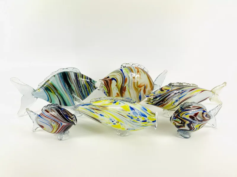 A collection of six Murano style art glass fish, all of various sizes and colours. 29cms wide x 9.5cms deep x 19cms high