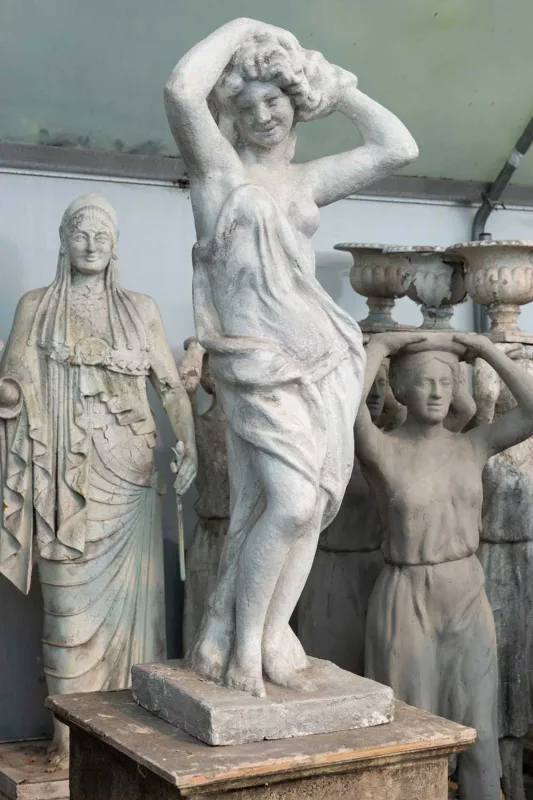 A fibreglass sculpture depicting a semi nude maiden The sculpture of the maiden with painted finish and on a square base