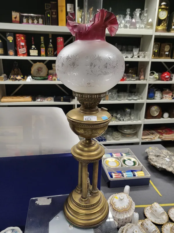 A Victorian Oil Lamp with pink cranberry tinged glass shade, and clear glass funnel