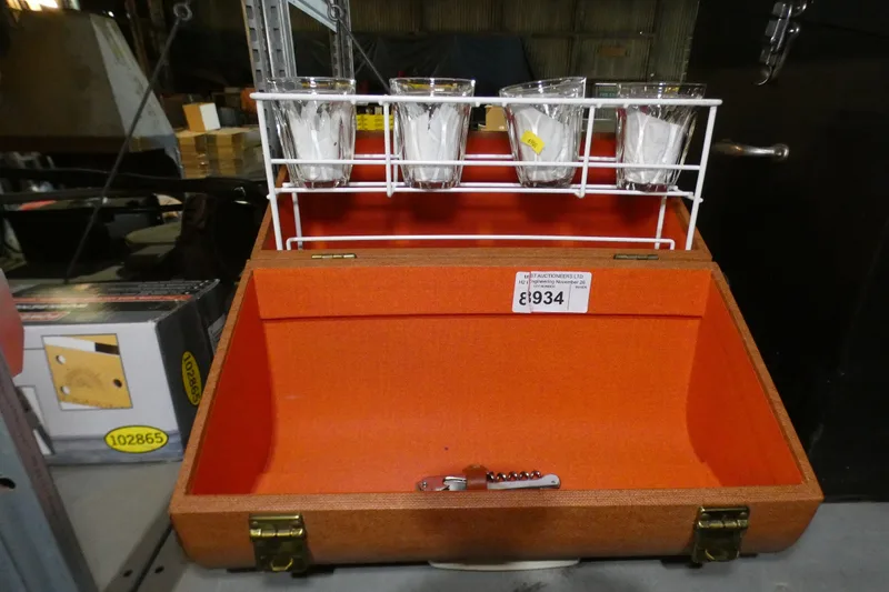 A vintage hard case drinks picnic hamper with 4 glasses and a cork screw / bottle opener