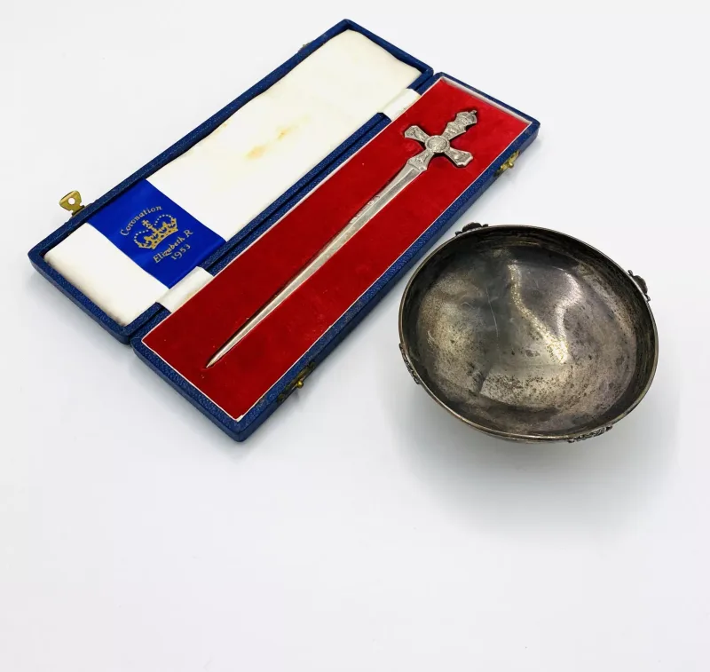 A silver bowl together with a silver letter opener