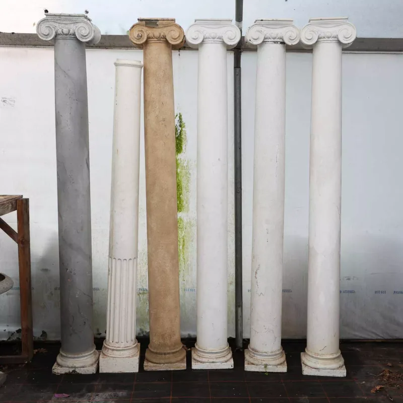 A set of five ionic columns and a further column shaft The painted composite columns with scroll ornamented capitals Each of the set of five
