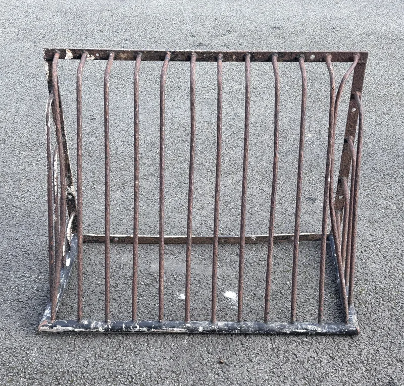 An early 20th century black painted cast-iron hay rack, 91cm wide