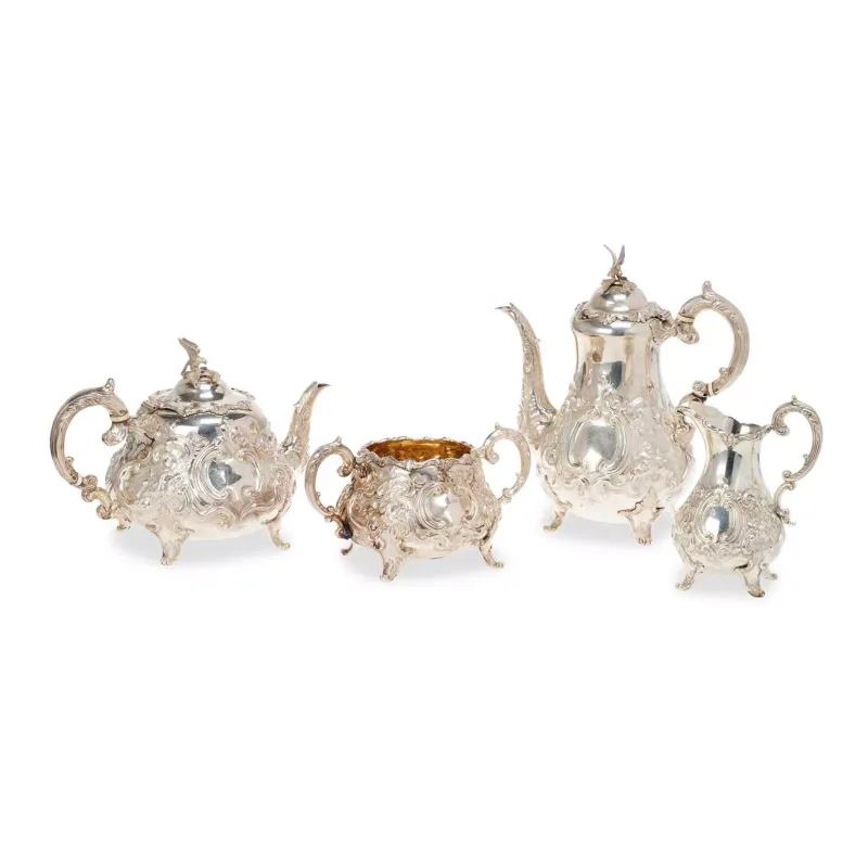 A Victorian Silver Four-Piece Tea Service § maker's mark W.H., London 1861, comprising a teapot, coffee pot, sugar bowl and milk jug, in Louis XIV type pattern