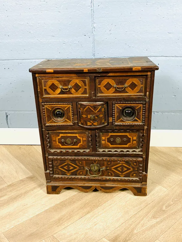 An unusual 19th century antique table cabinet with an arrangement of various drawers