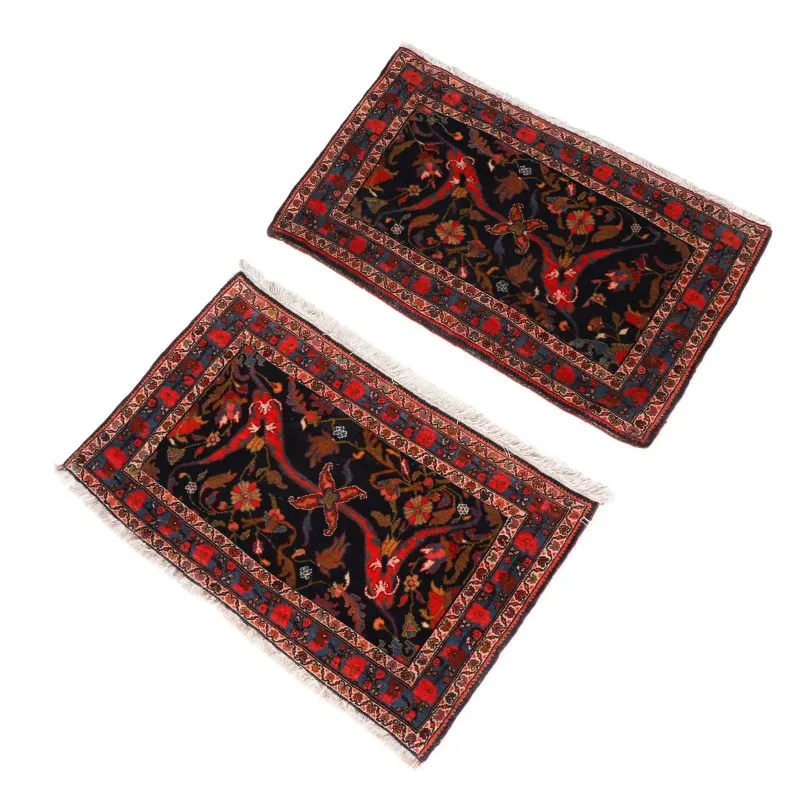 A Pair Of Senneh Rugs early 20th Century, each indigo field with a central floral spray and curling serrated leaves within a flowering vine border
