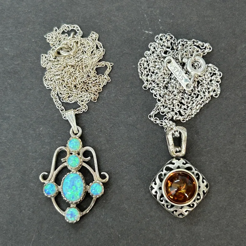 A 925 sterling silver and opal set necklace on 18" chain together with a 925 and amber set necklace on 16" chain