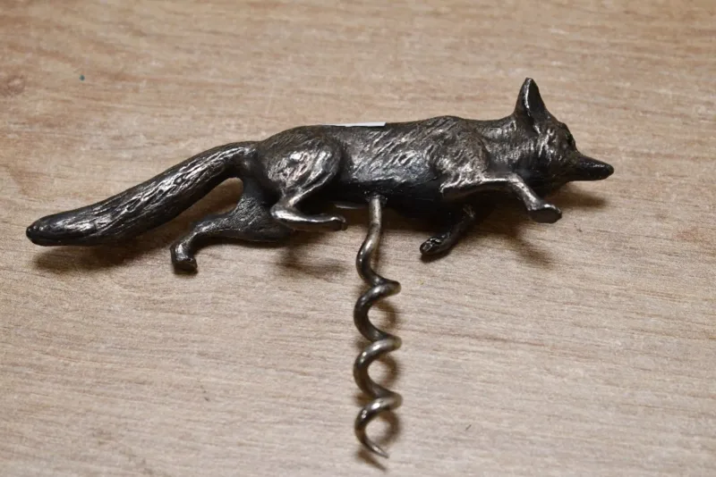 A heavy early 20th-century white metal fox cork screw, modelled in a stalking pose, unmarked, fox is