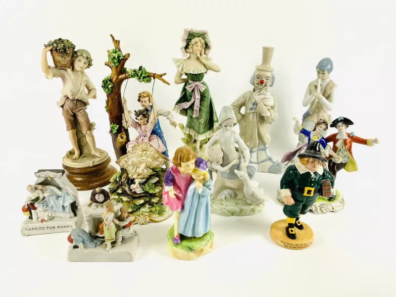 A collection of eleven various porcelain figurines to include Royal Doulton and Royal Worcester. 16cms wide x 15cms deep x 28.5cms high (largest)