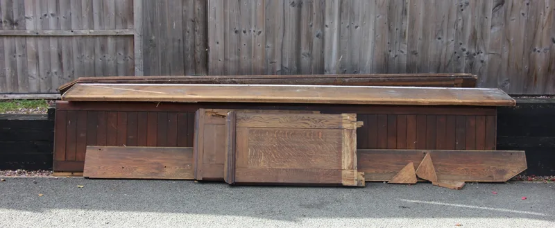 A large Victorian oak church pew, with panelled back, solid seat (unassembled)