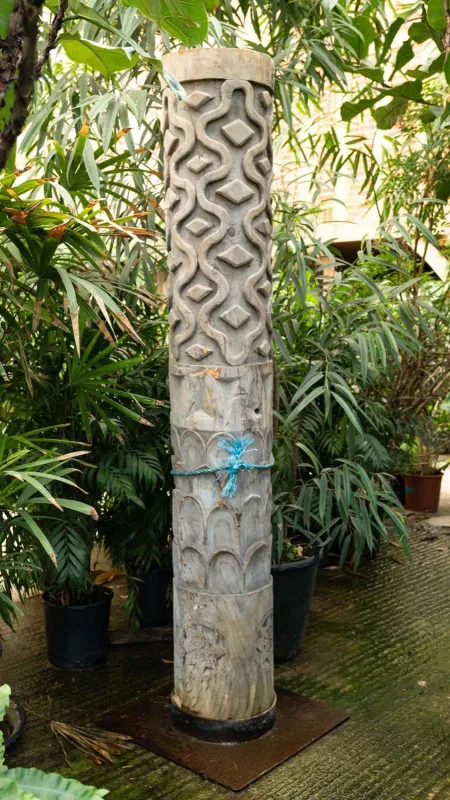 A large carved wooden totem style pole The cylindrical pole with bands of stylised ornament
