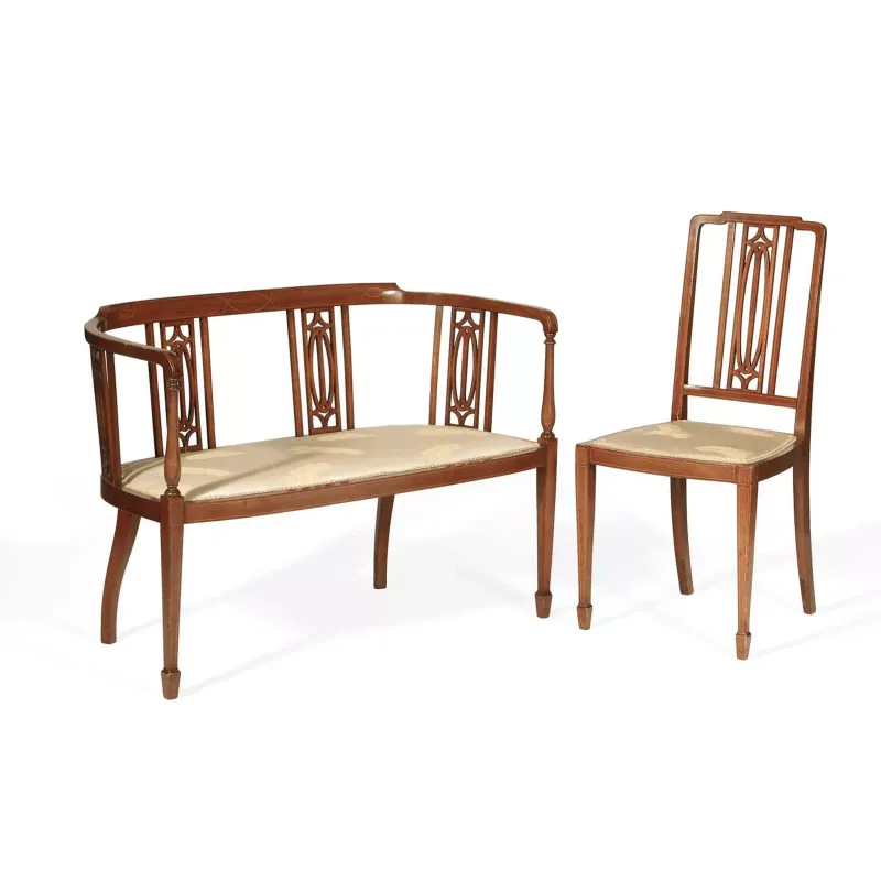 An Edwardian Inlaid Mahogany Salon Settee And Chair circa 1905, the settee with a curved top rail above pierced and inlaid splats