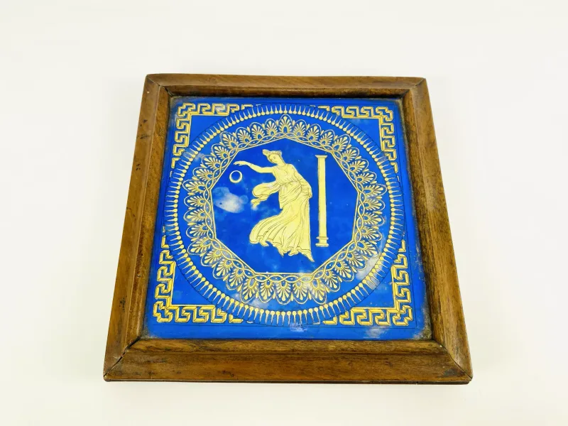 A 19th century walnut framed tile top teapot stand with turned bun feet, the tile possibly Mintons. 25cms wide x 25cms deep x 4.5cms high