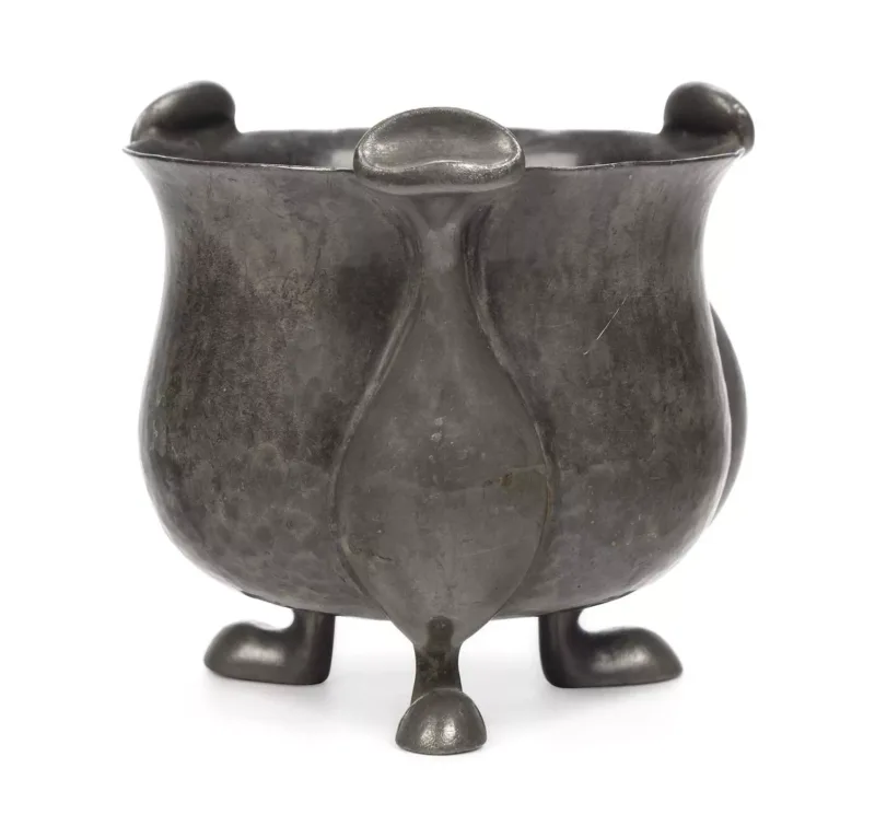 Oliver Baker For Liberty & Co, A Tudric Pewter Bowl with a planished finish, and set upon three pod feet,