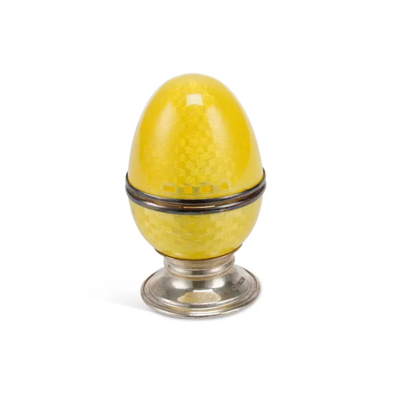 An Elizabeth II Silver And Enamel Egg On Stand marked Mc, Sheffield 1998, in yellow guilloché enamel, opening at the centre to reveal a fabric-lined interior