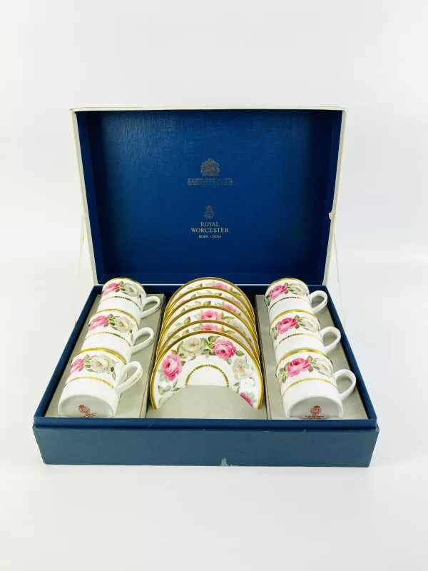 A boxed Royal Worcester set of six coffee cans and saucers, decorated in the 'Royal Garden' pattern