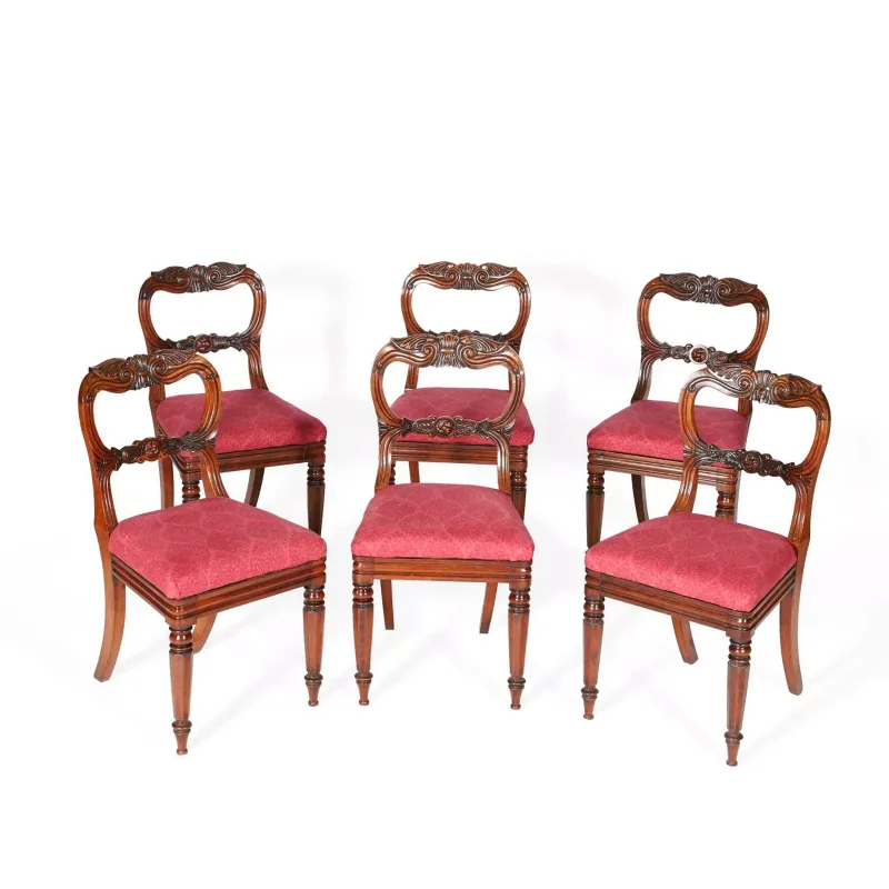 A Set Of Six William IV Rosewood Dining Chairs circa 1835, each with a scroll carved top rail above a conforming mid rail