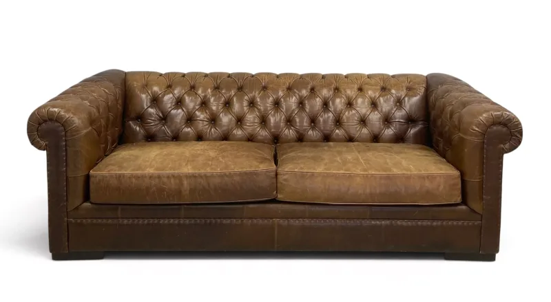 A contemporary brown leather upholstered chesterfield sofa with two large seats and scrolled, deep buttoned back and arms