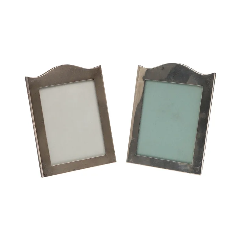 A Pair of Silver Fronted Serpentine Top Photograph Frames