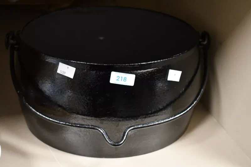 A large late 19th to early 20th-century cast iron oval pot, unmarked,