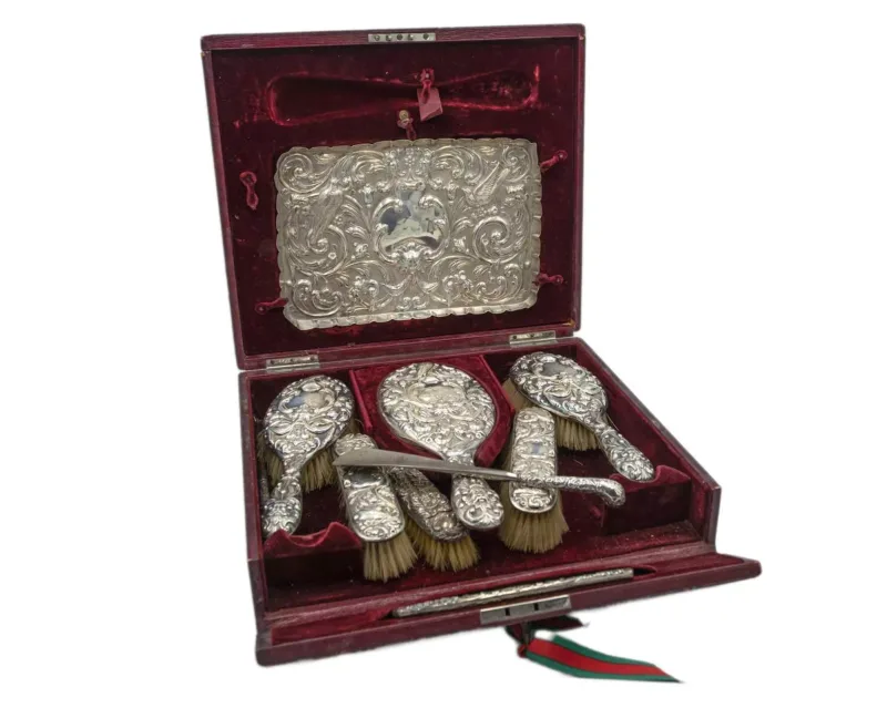 A Victorian cased silver dressing table vanity set by William Comyns & Sons Ltd