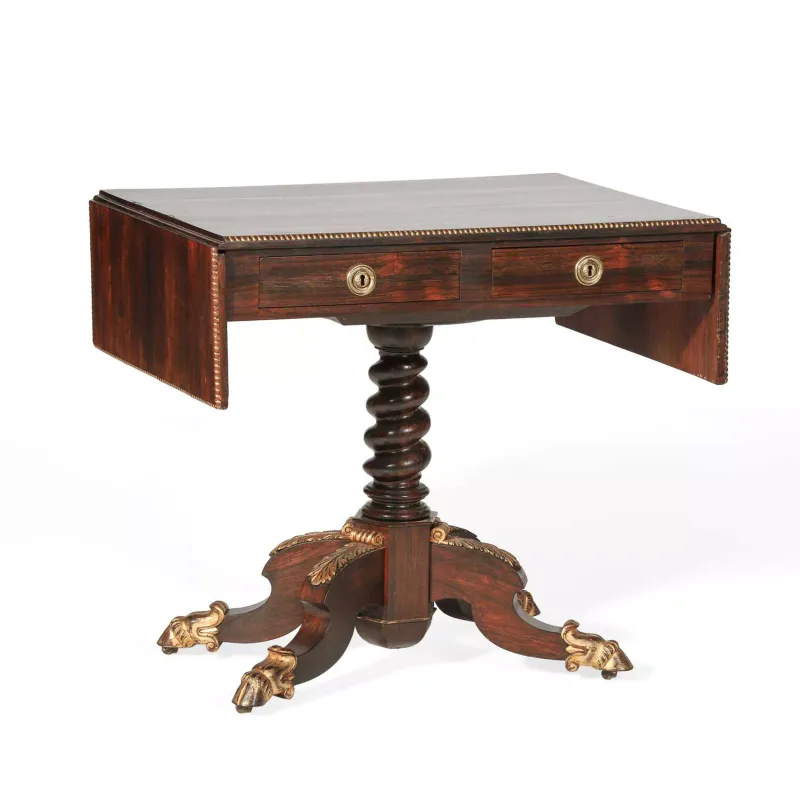 A Regency Style Rosewood Sofa Table the rectangular top with twin drop leaf ends and a beaded edge, above two frieze and two dummy drawers