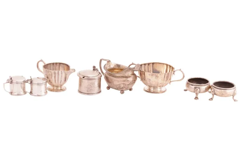 A collection of miscellaneous silver items, comprising a sugar bowl by Lambert & Co, London 1911, of shaped faceted form with twin scroll handles