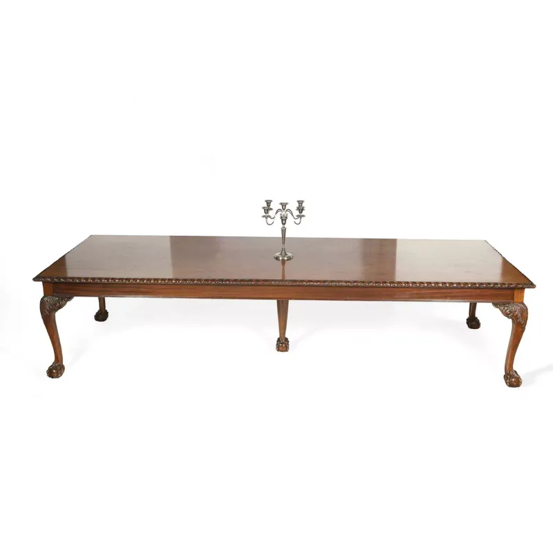 A Large Mahogany Dining Table late 19th or early 20th Century, in the George II taste, the rectangular top with a gadrooned edge above a plain frieze