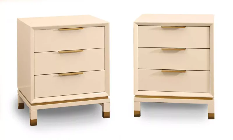 A pair of Robert Langford white lacquered bedside chests, of recent manufacture, each with three drawers, bronzed handles and supports