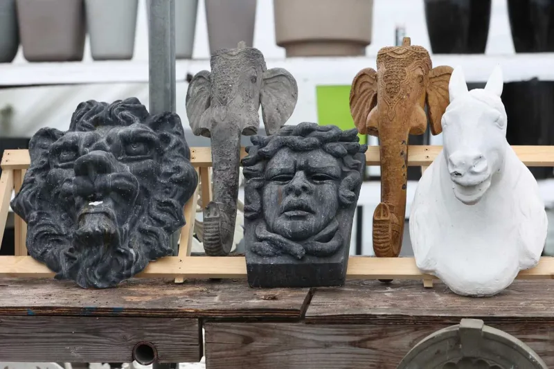 A group of five masks for wall mounting To include one of Medusa and another of a lion, the Medusa plaque in plaster