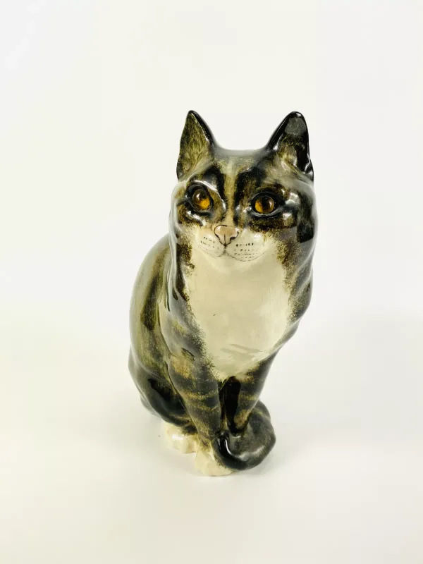 A large Winstanley pottery sculpture of a cat with glass eyes, fully marked to the underside. 14cms wide x 26cms deep x 32cms high