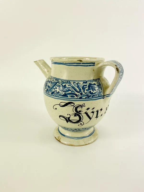 A good 18th century or earlier Italian pottery tin glazed wet drug jar with pouring spout, marked to the main body 'Syrup Absinthe'