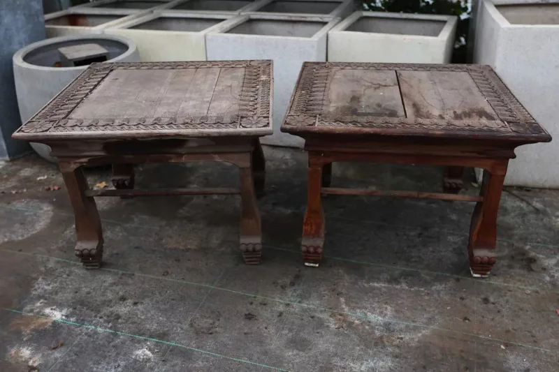 A pair of Indian style conservatory tables The square topped tables each with a band of pine cone and guilloche ornament and on shaped legs