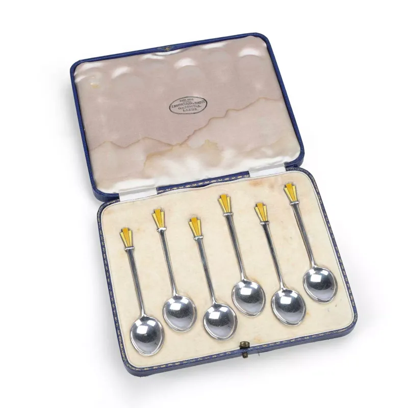 A Cased Set Of Six Art Deco Silver And Enamel Coffee Spoons by W H Haseler Ltd, Birmingham 1939, each with yellow enamelled fan-shaped terminal
